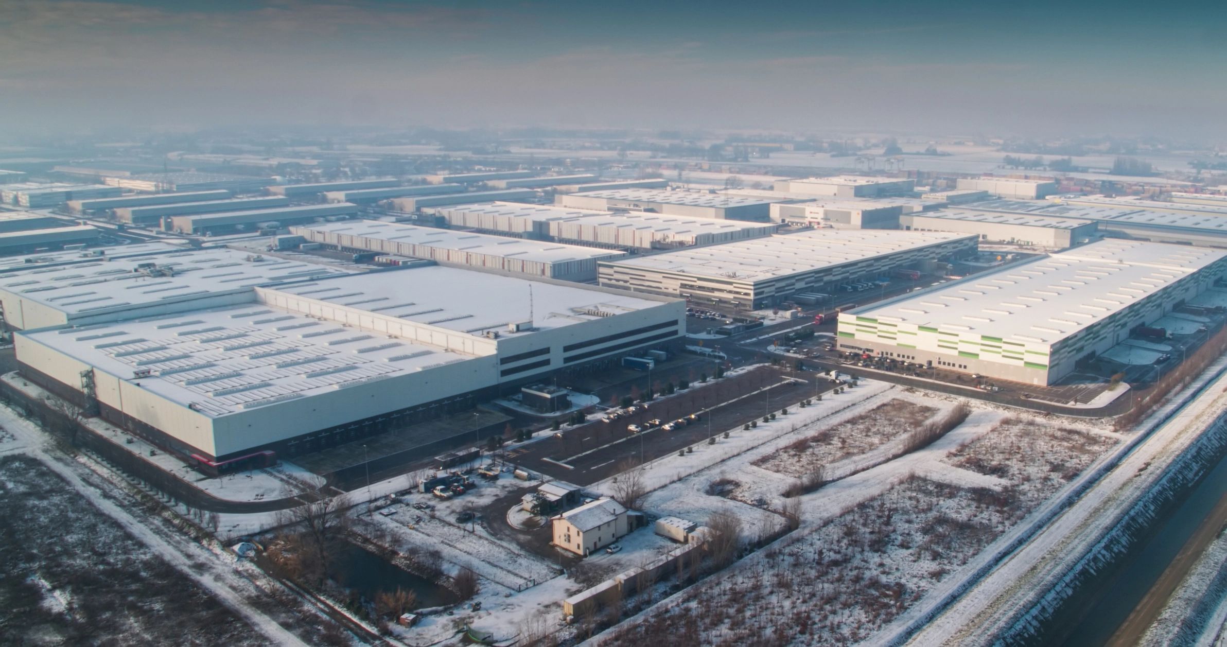 Aerial view of a large industrial complex and surrounding land